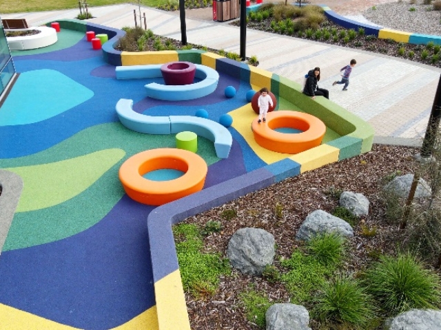 A playground with colorful playground equipment Description automatically generated with medium confidence