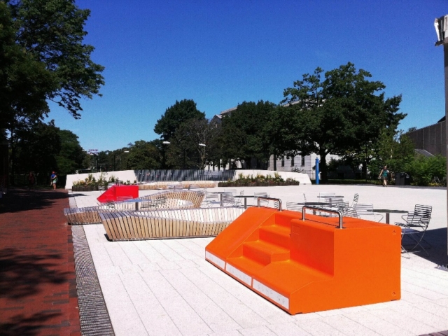 An orange and white benches in a park Description automatically generated